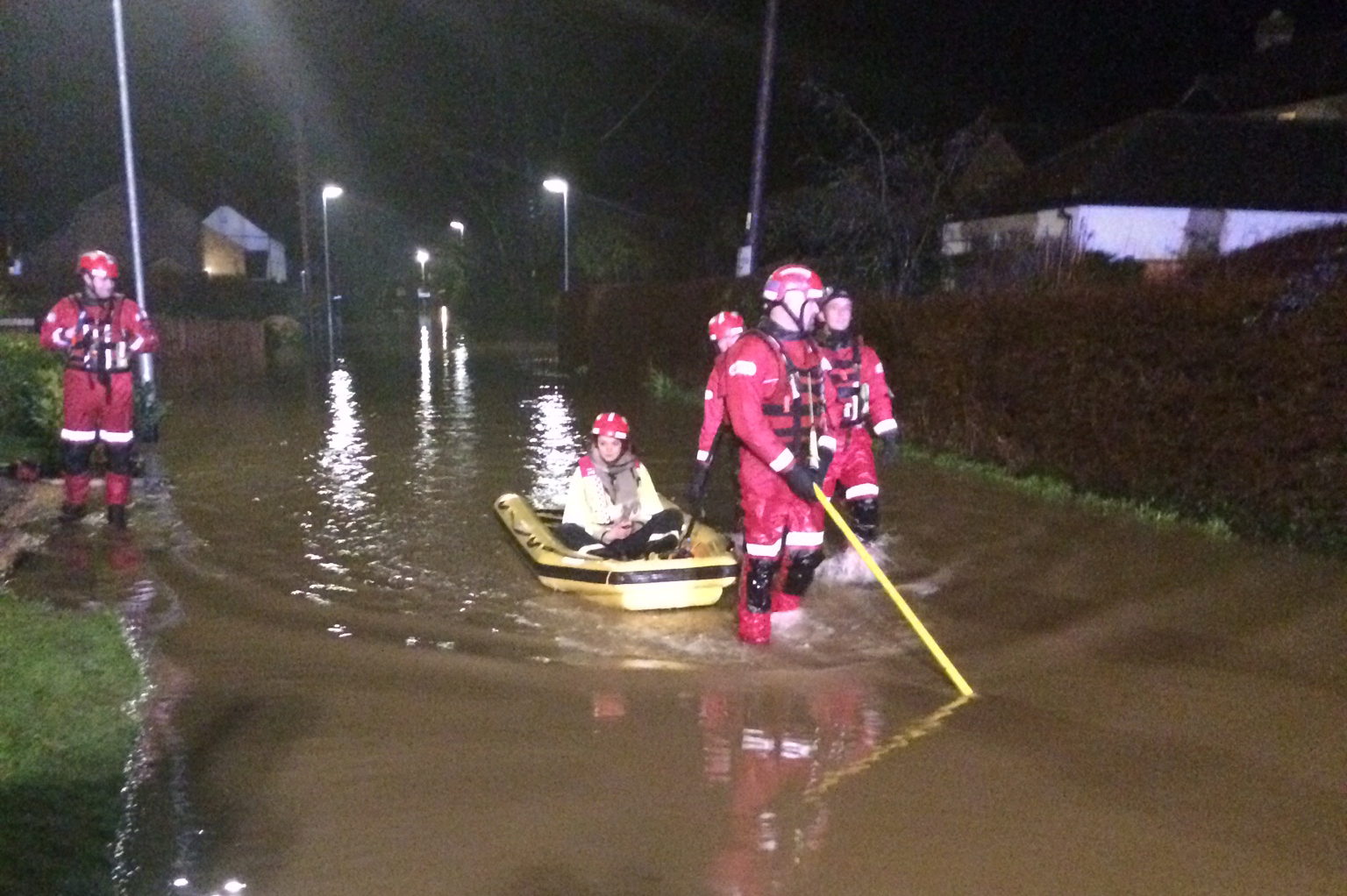 firefighters rescuing resident using rescue boat