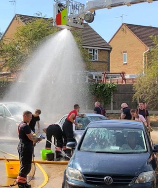 firefighters cleaning cars