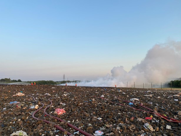 Firefighters tackling fire in the open