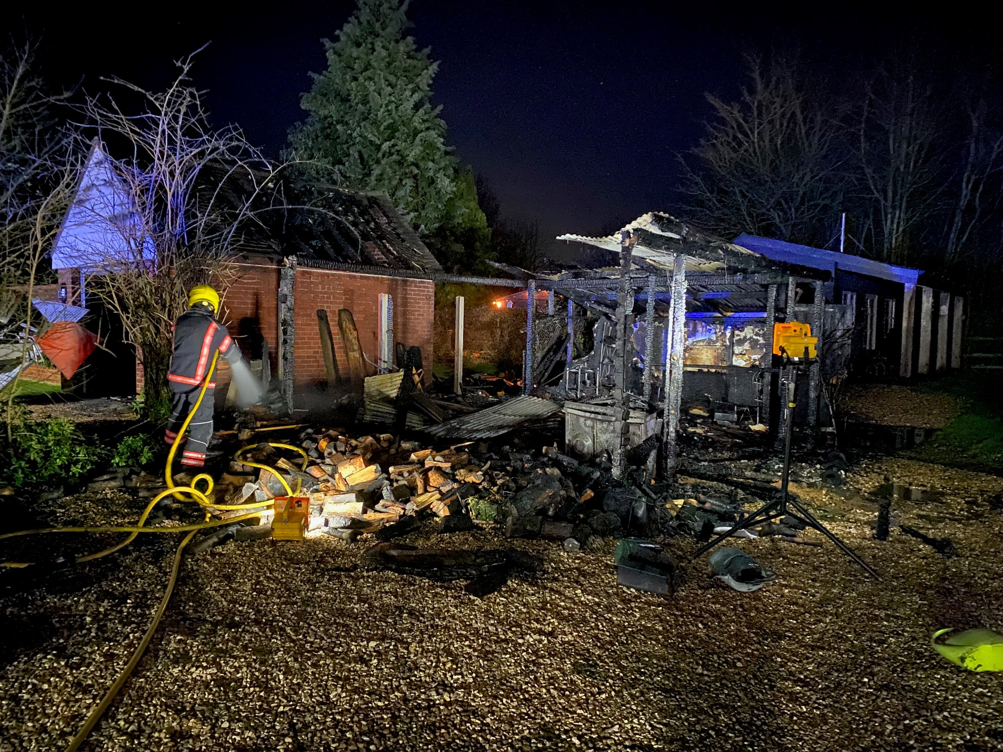 Firefighter tackling garage fire