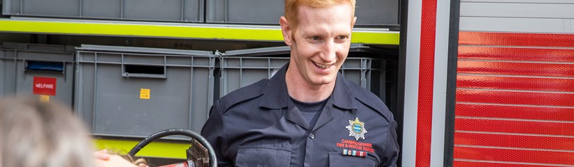 Firefighters with group of children