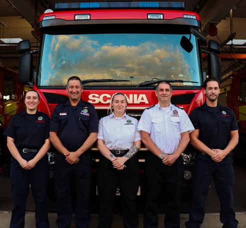 Picture of the Gould family standing in front of a fire engine